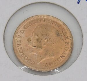 Old British coin with King George V profile.