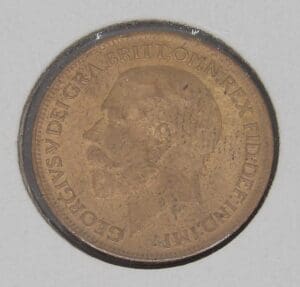 A coin featuring a profile of a man with text around the edge.